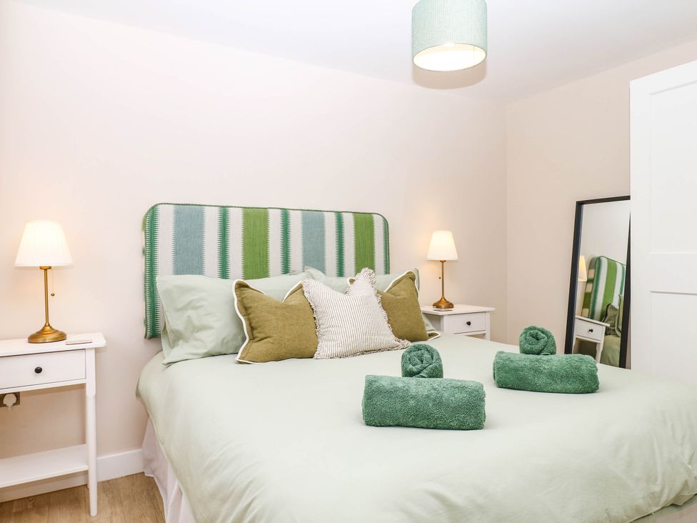 A bedroom with a bed and towels on it at Little Folley in Whitestone near Tedburn St Mary