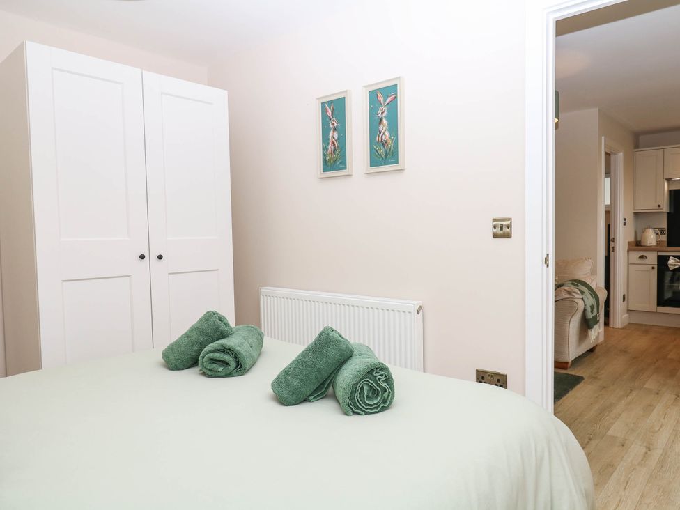 A bedroom with towels on the bed at Little Folley in Whitestone near Tedburn St Mary