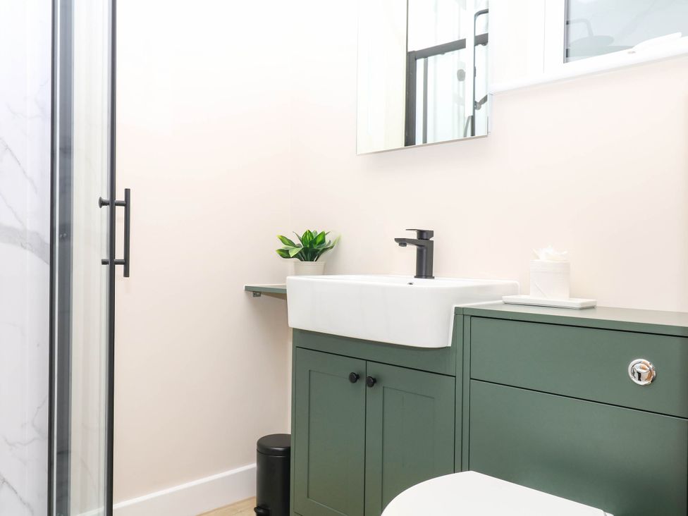 A bathroom with a sink and shower at Little Folley in Whitestone near Tedburn St Mary