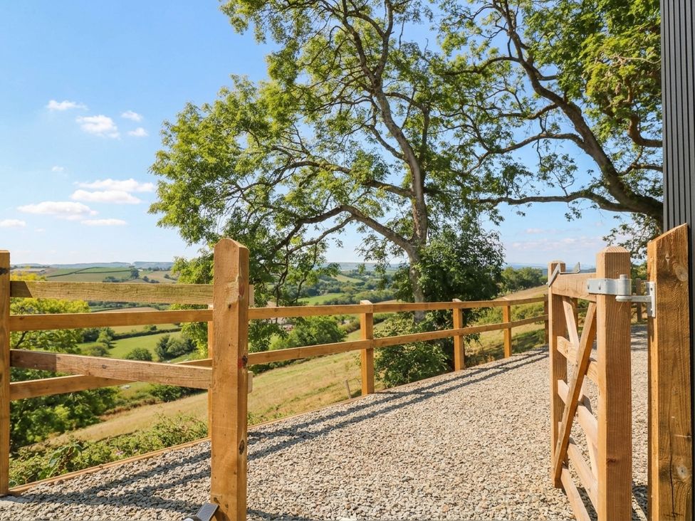 An outdoor area with a wooden fence and gate at Little Folley in Whitestone near Tedburn St Mary