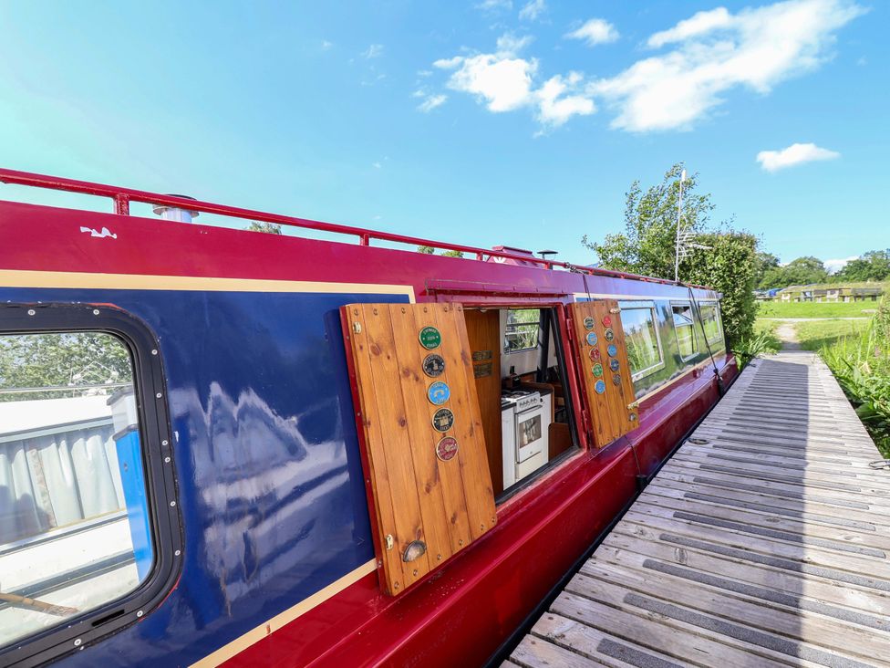 A boat with a wooden panel and pathway at Escape II Oakwood Marina