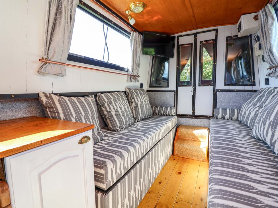 A living room with sofa and television at Escape II in Oakwood Marina
