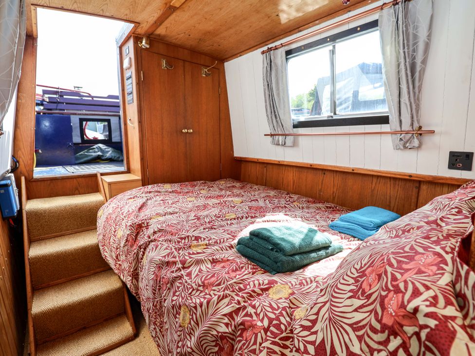 A bedroom with a bed and staircase at Escape II in Oakwood Marina