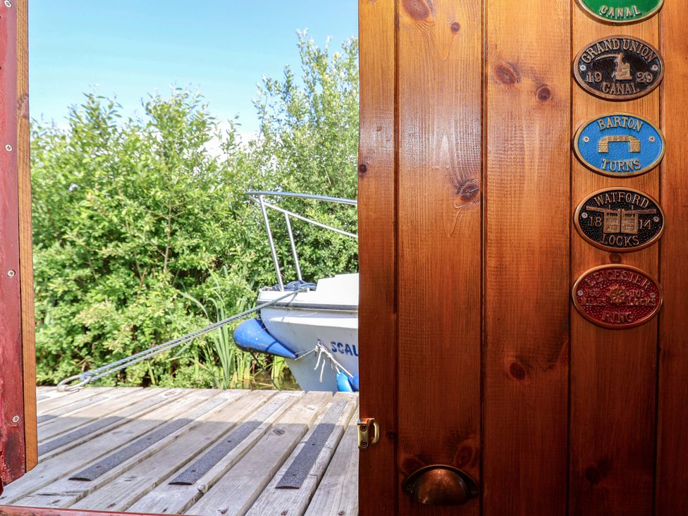 A view of a boat from a wooden door at Escape II Oakwood Marina