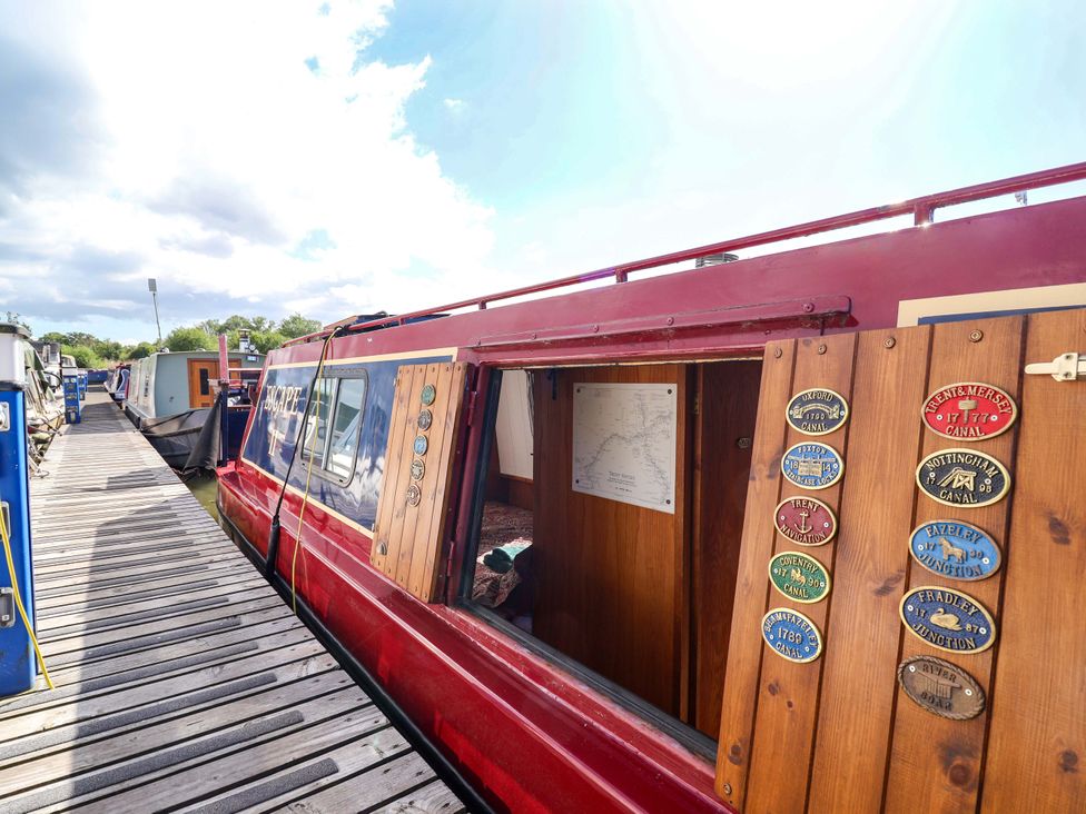 A boat with wooden plaques and map at Escape II in Oakwood Marina