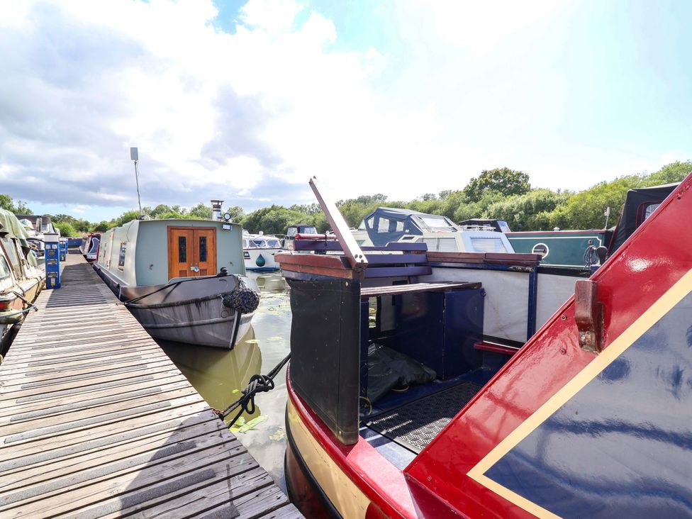 A dock with boats and greenery at Escape II Oakwood Marina