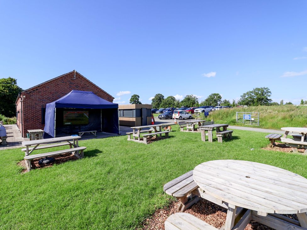 An outdoor area with picnic tables and a tent at Escape II in Oakwood Marina