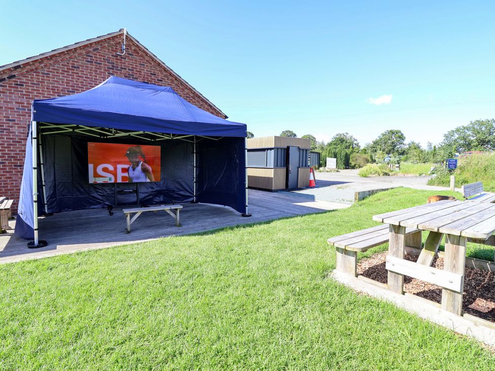 A tent with a television and seating area at Escape II Oakwood Marina