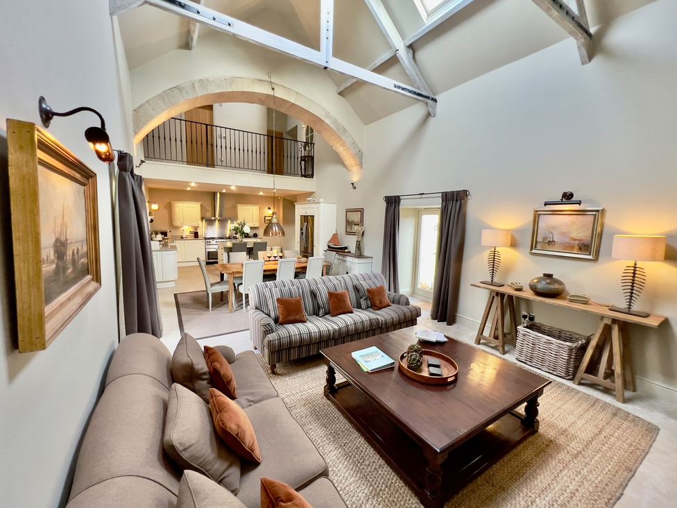 A living room with a sofa and coffee table at The Chimney in Bamburgh