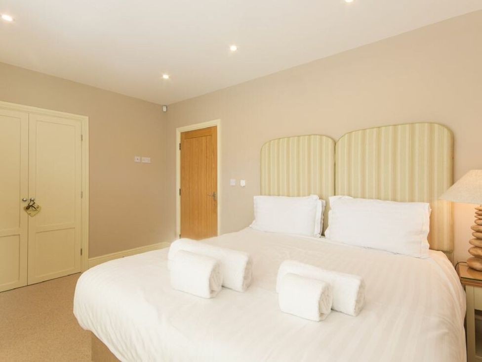 A bedroom with a bed and bedside lamp at The Chimney in Bamburgh