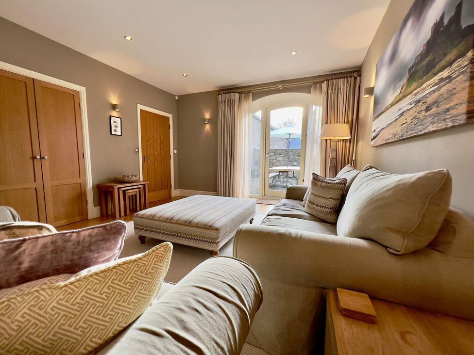A living room with a sofa and coffee table at The Chimney in Bamburgh