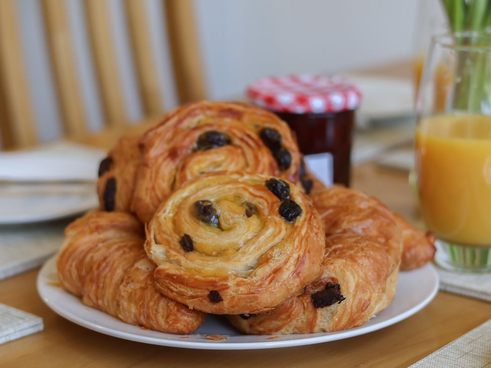 A plate of pastries with a jar and a glass of juice at Helmsley Cottage, Helmsley