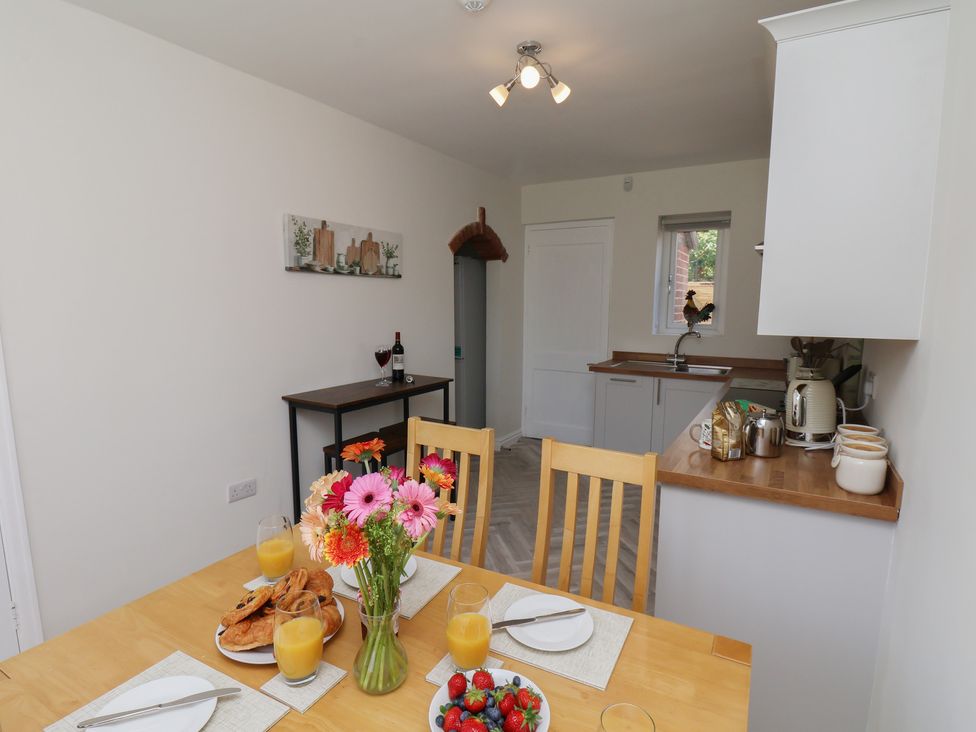 A kitchen with a dining table and chairs at Helmsley Cottage in Helmsley