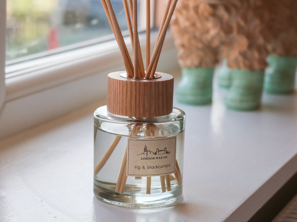A reed diffuser on a windowsill at Helmsley Cottage in Helmsley