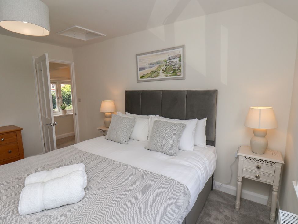 A bedroom with a bed and bedside tables at Helmsley Cottage in Helmsley