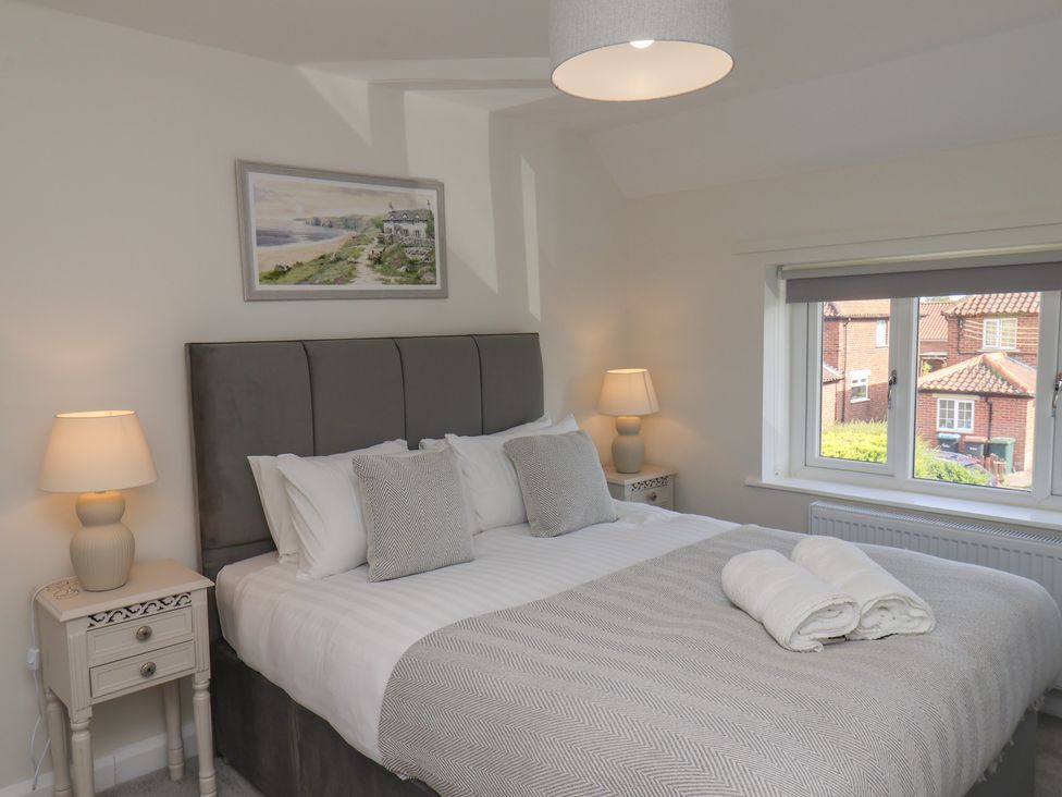 A bedroom with a bed and bedside tables at Helmsley Cottage in Helmsley