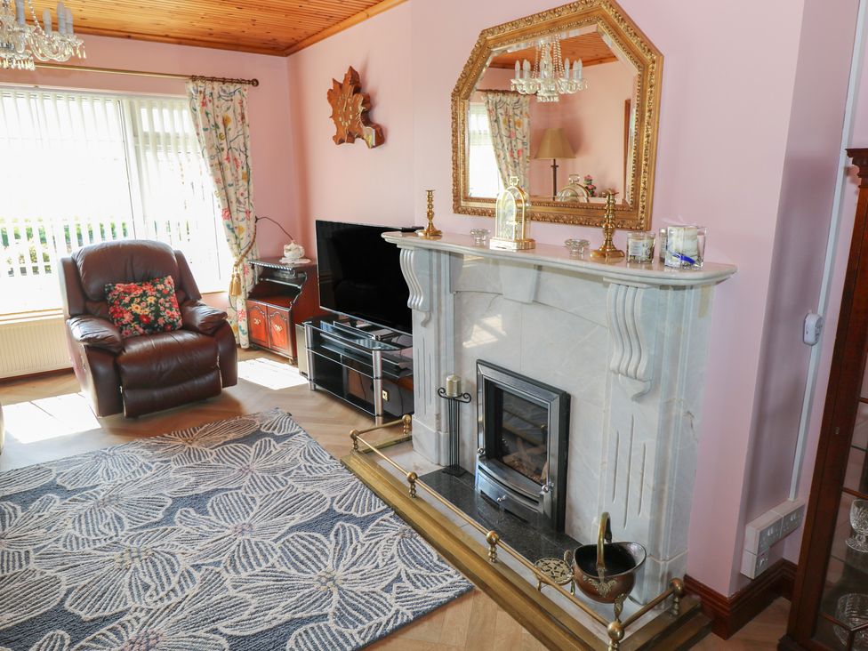 A living room with a fireplace and television at Marie's Country Home in Ardee, County Louth