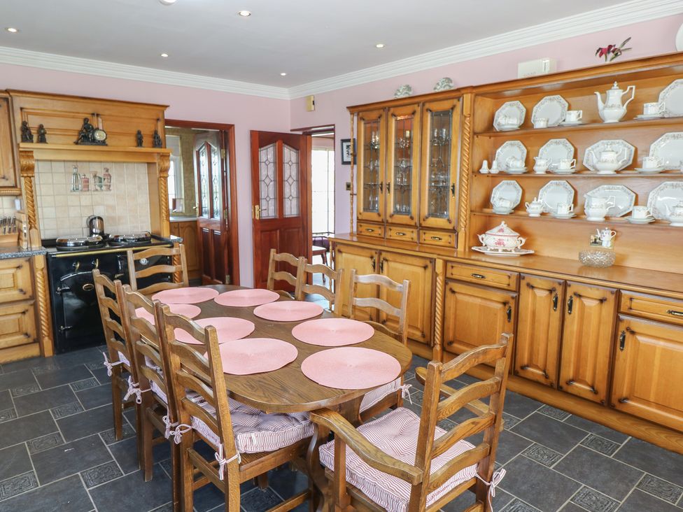 A kitchen with a wooden table and chairs at Marie's Country Home, Ardee, County Louth