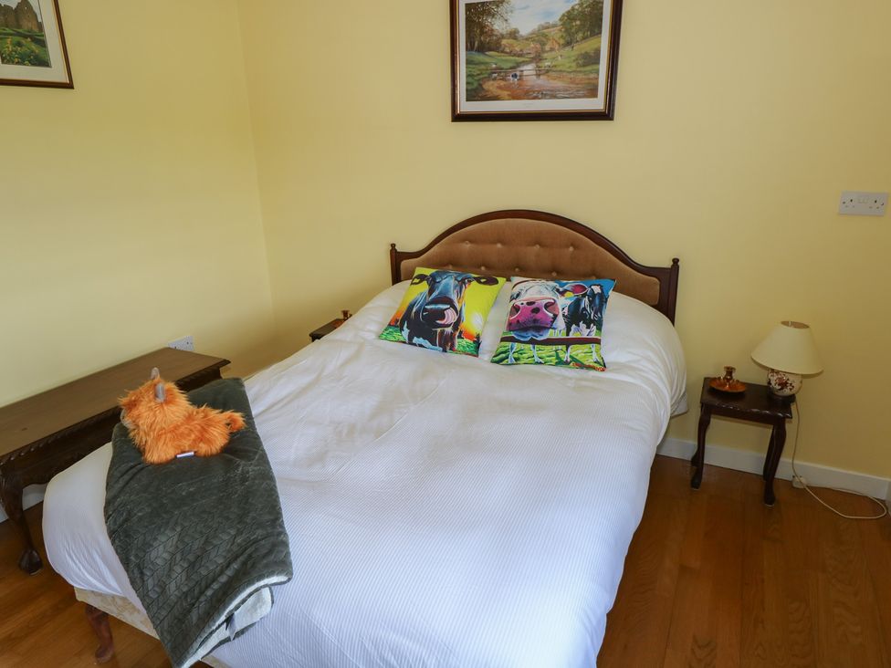 A bedroom with a bed and decorative pillows at Marie's Country Home, Ardee, County Louth