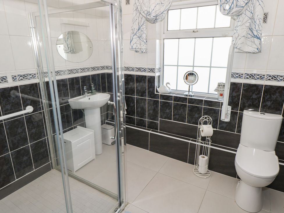 A bathroom with a shower, sink, and toilet at Marie's Country Home, Ardee, County Louth