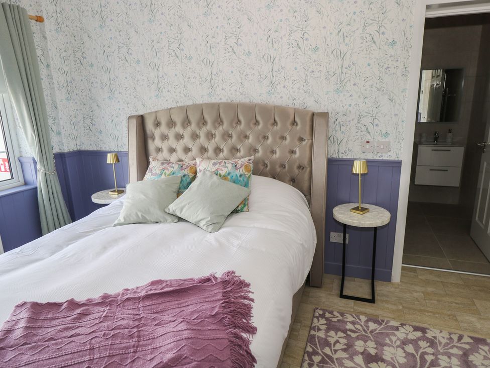 A bedroom with a bed and side tables at Marie's Country Home in Ardee, County Louth
