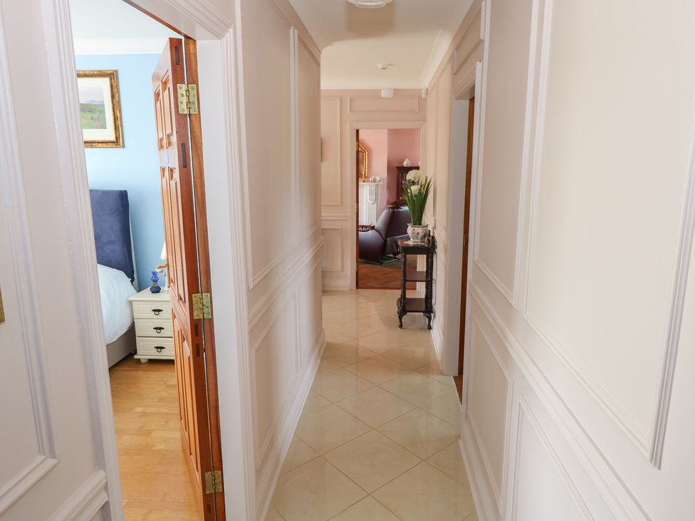 A hallway with doors to rooms and furniture at Marie's Country Home Ardee, County Louth