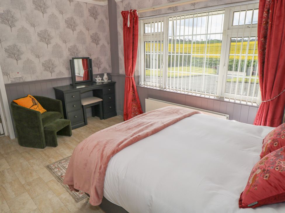 A bedroom with a bed and a mirror at Marie's Country Home, Ardee, County Louth