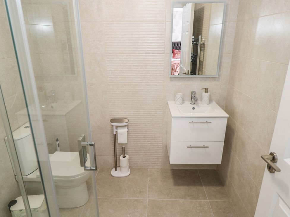 A bathroom with a shower, toilet, and sink at Marie's Country Home in Ardee, County Louth