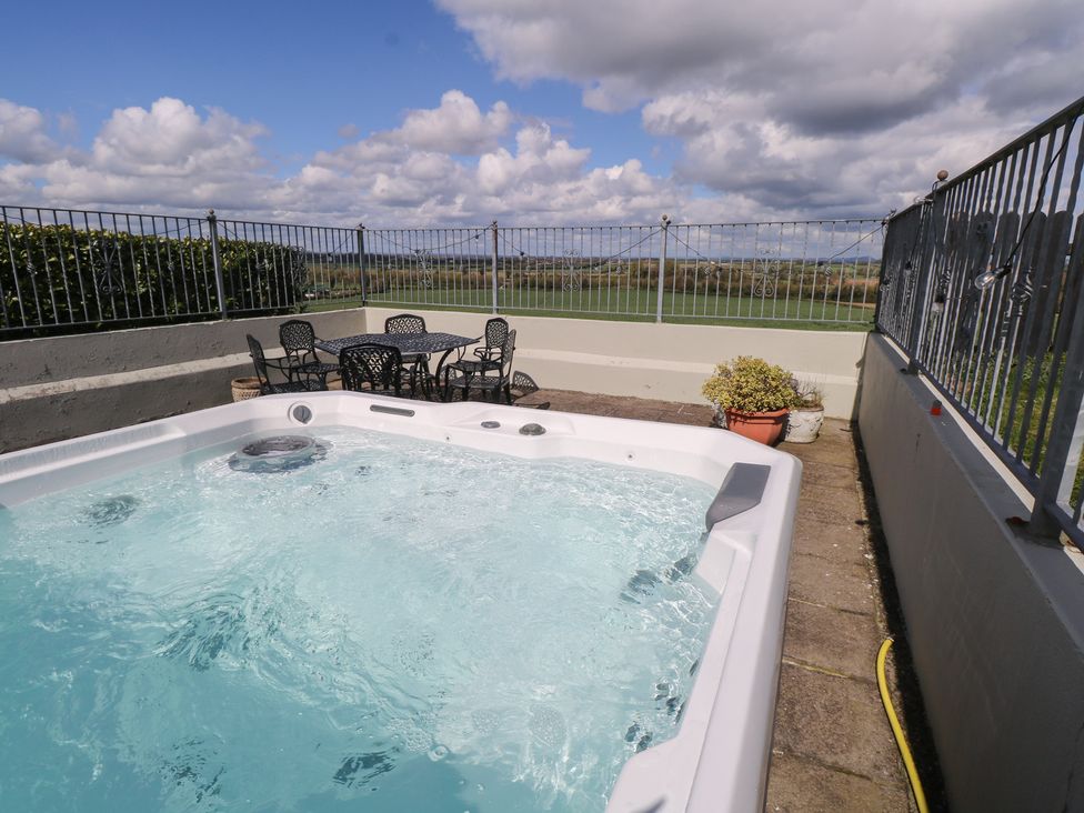 An outdoor area with a hot tub and seating at Marie's Country Home, Ardee, County Louth