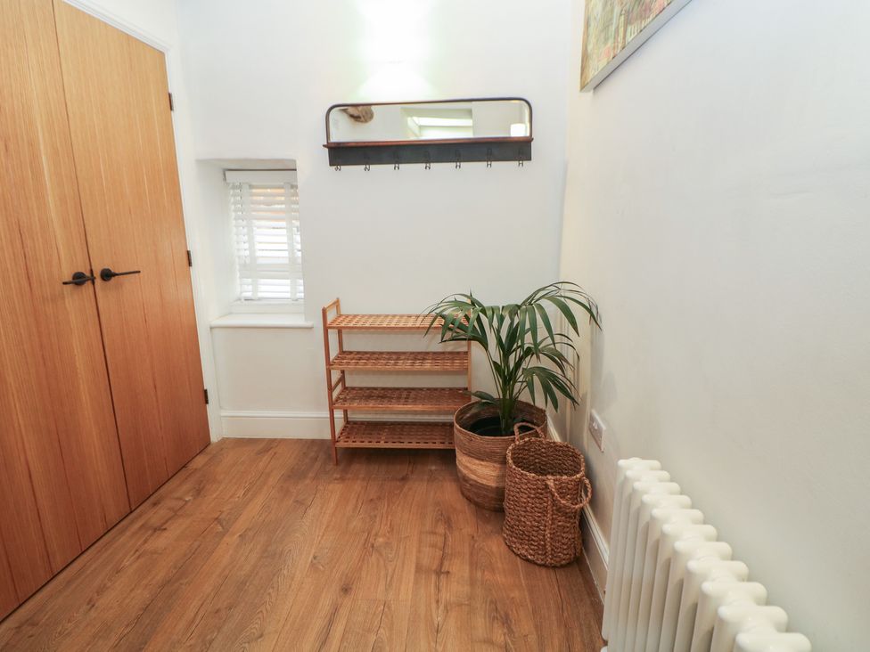 A hallway with a shelf and a plant at Holly Cottage in Totley