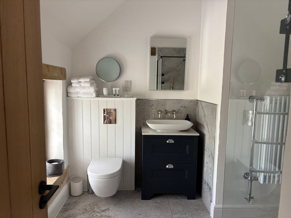 A bathroom with a toilet, sink, and shower at Holly Cottage in Totley