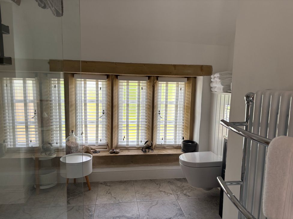A bathroom with a toilet and towel radiator at Holly Cottage in Totley