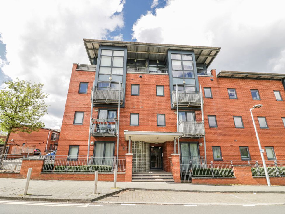A residential building with balconies and trees nearby at Apartment 10 in Birmingham