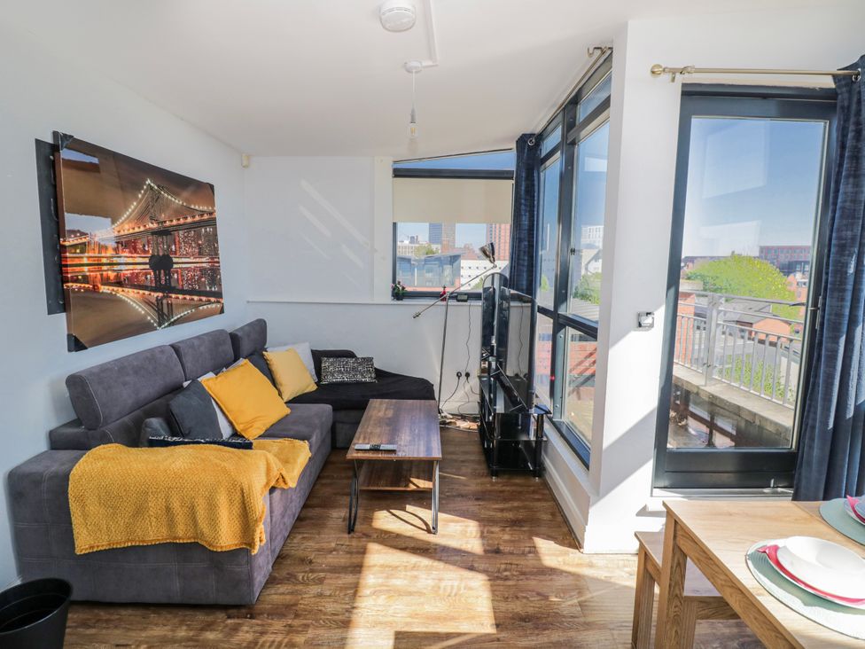 A living room with a sofa and television at Apartment 10 in Birmingham