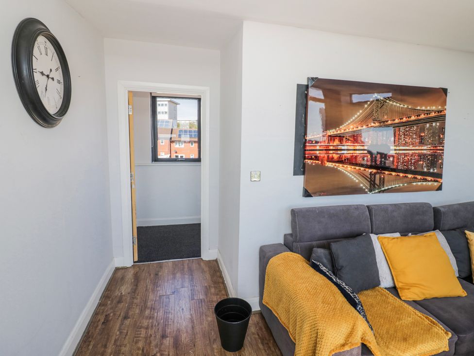 A living room with a sofa and wall art at Apartment 10 in Birmingham