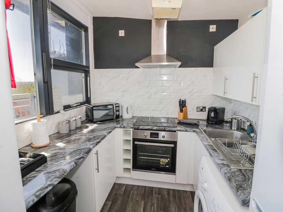 A kitchen with appliances and countertop at Apartment 10 in Birmingham