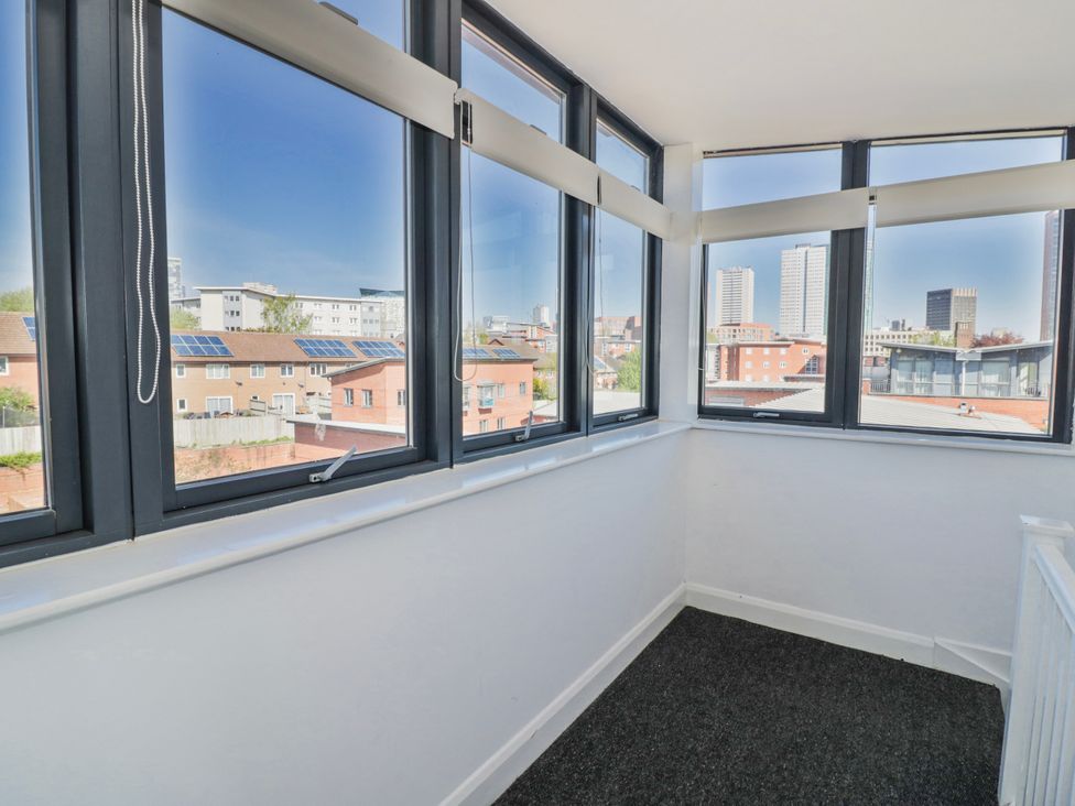 A sunroom with multiple windows at Apartment 10 in Birmingham
