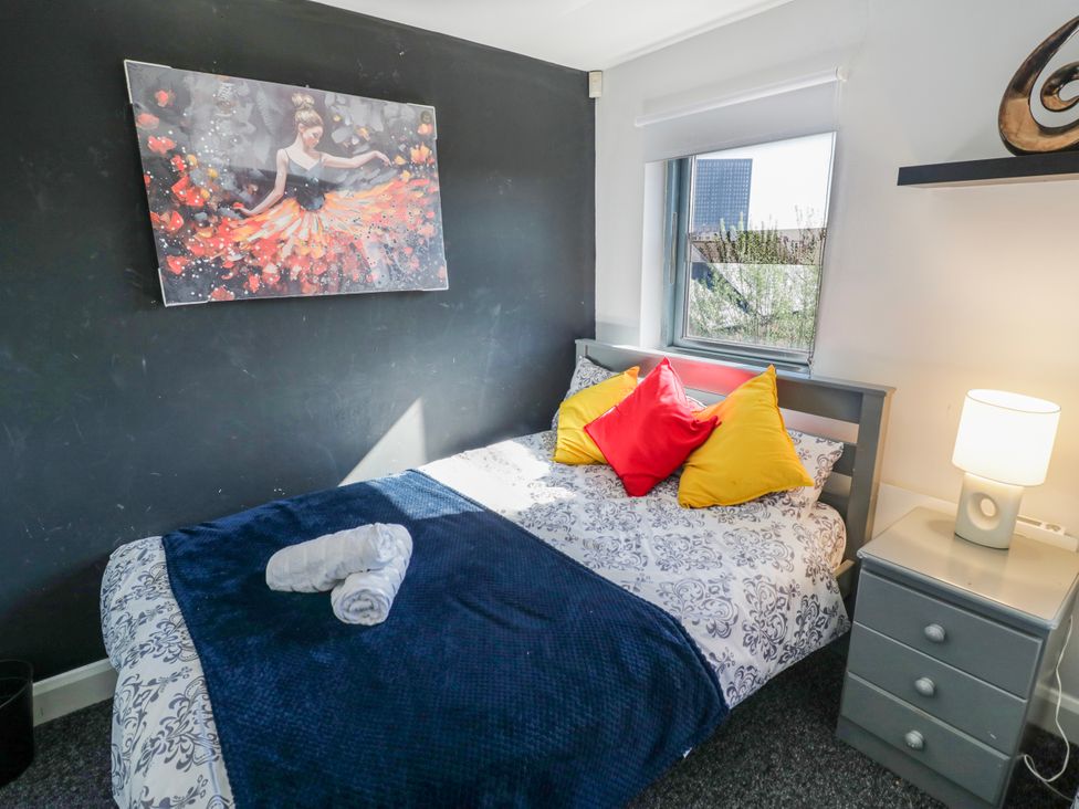 A bedroom with a bed and nightstand at Apartment 10 in Birmingham