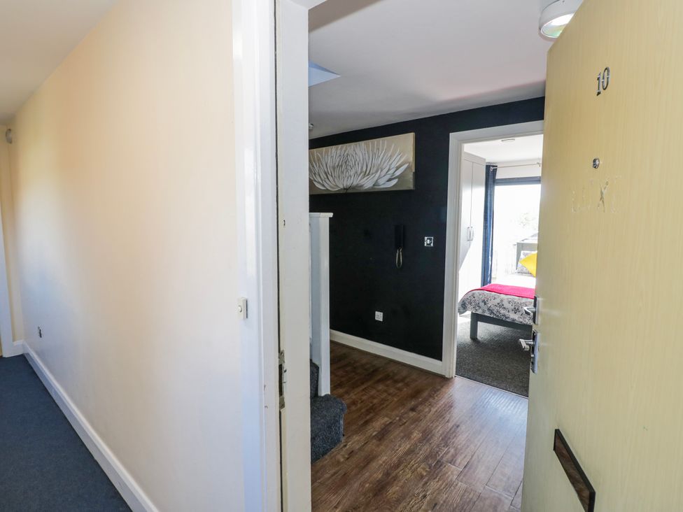 A hallway with a door leading to a bedroom at Apartment 10 in Birmingham
