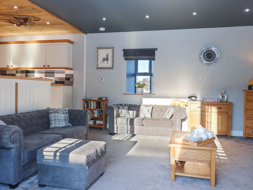 A living room with a sofa and coffee table at The Steading in Dumfries