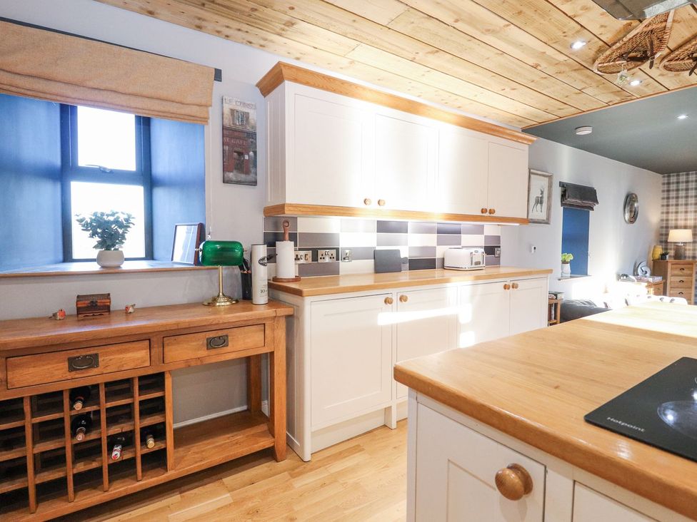 A kitchen with a wine rack and countertop at The Steading in Dumfries