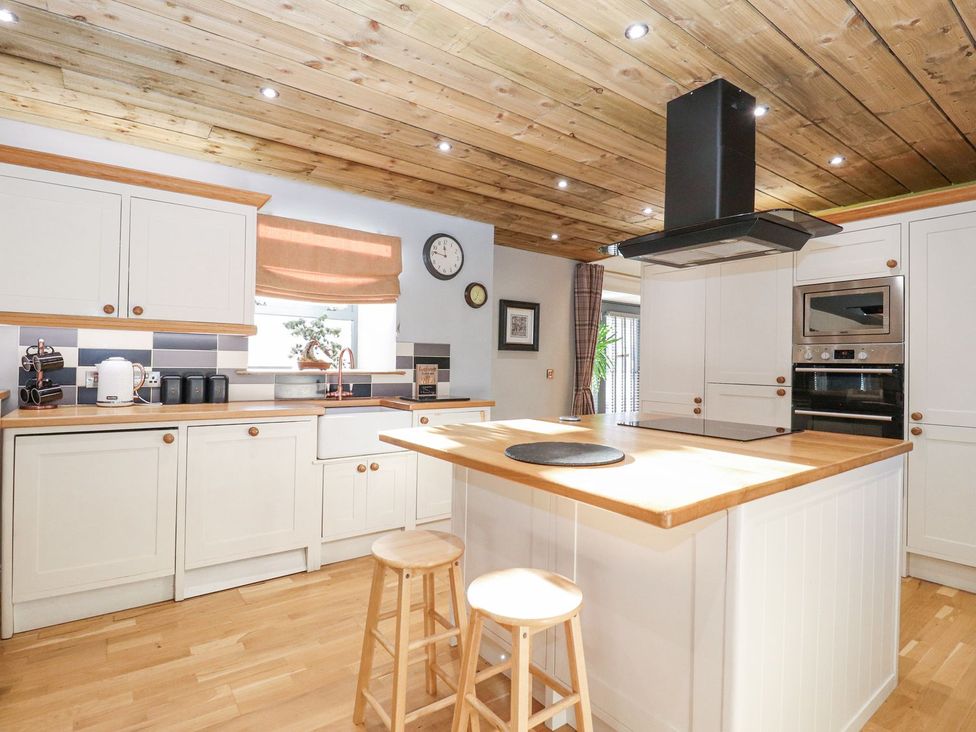 A kitchen with cabinets and a kitchen island at The Steading in Dumfries