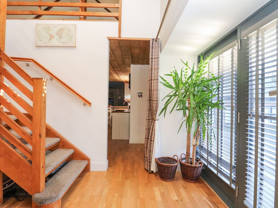 An entrance with a staircase and potted plant at The Steading in Dumfries