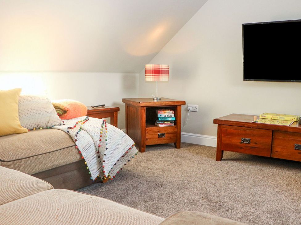 A living room with a sofa and side tables at The Steading in Dumfries