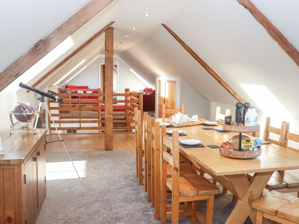 A dining room with a table and chairs at The Steading in Dumfries