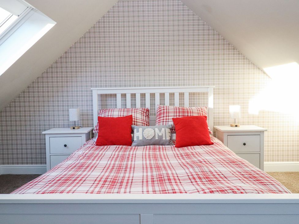 A bedroom with a bed and bedside tables at The Steading in Dumfries