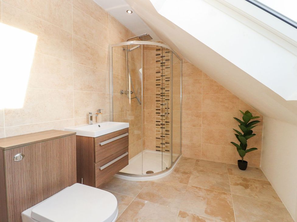 A bathroom with a shower and sink at The Steading in Dumfries