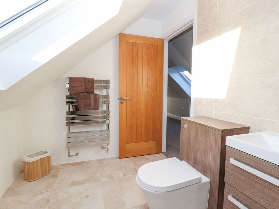 A bathroom with a toilet and sink at The Steading in Dumfries