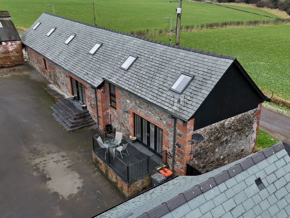 An outdoor view of a building with steps and a deck at The Steading Dumfries