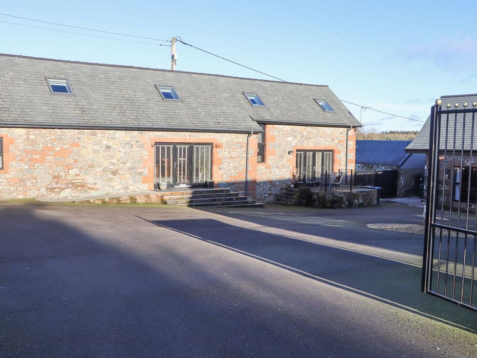 A building with windows and doors in a parking area at The Steading in Dumfries
